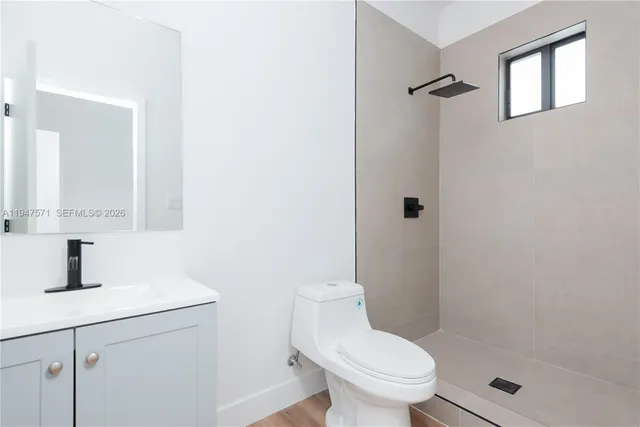 a bathroom with a toilet sink and shower