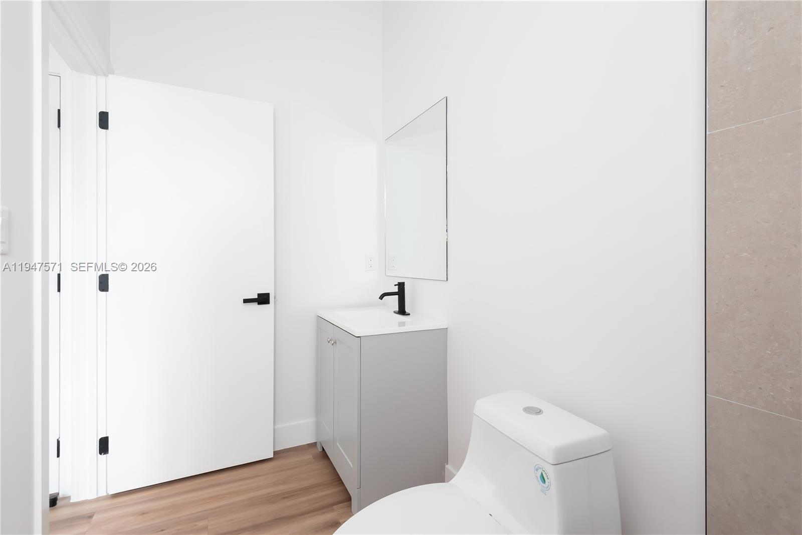 4517 Northwest 3rd Street Miami, FL 33126 - Photo 20 of 34 a white toilet sitting next to a bathroom sink