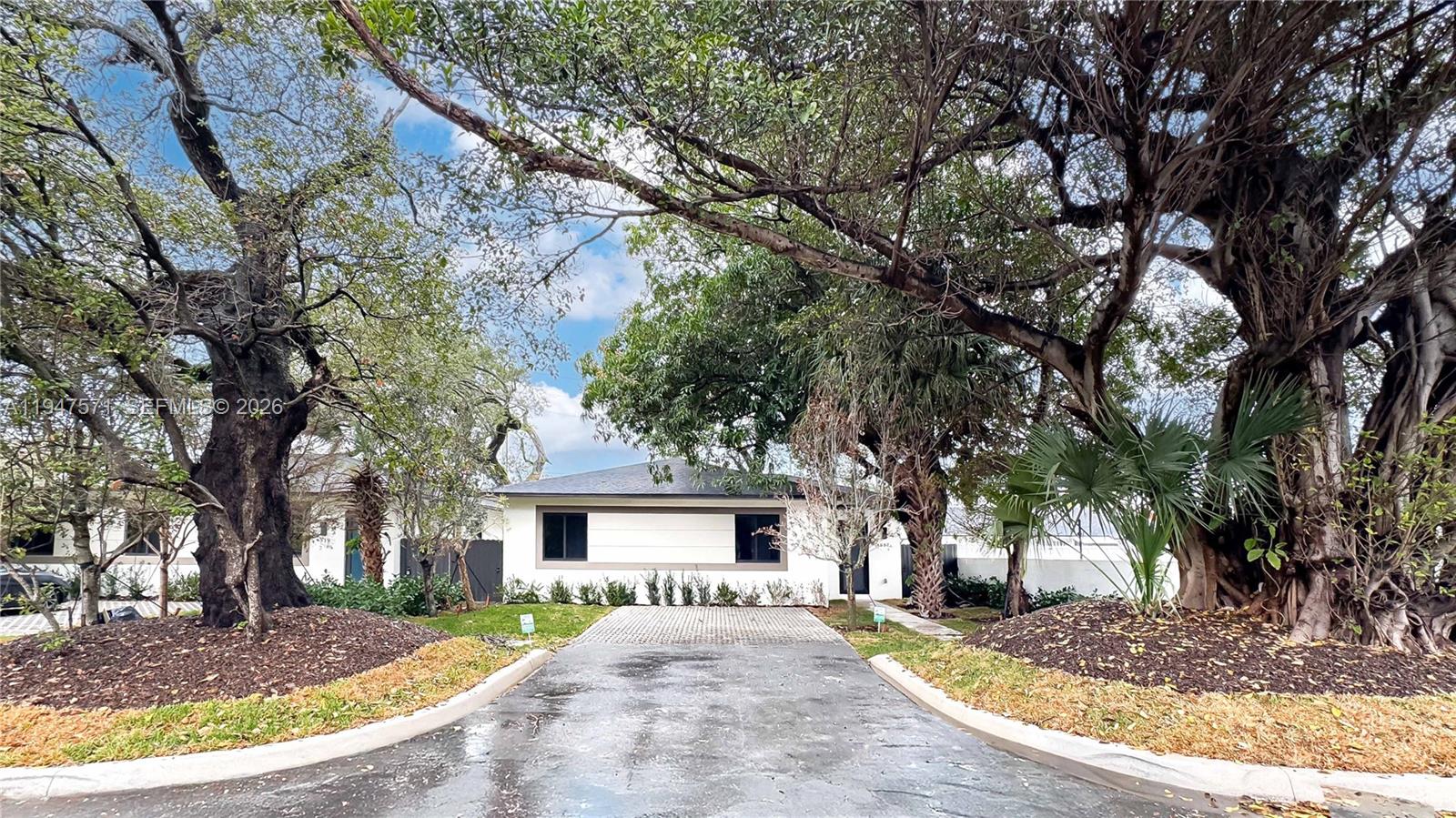 4517 Northwest 3rd Street Miami, FL 33126 - Photo 2 of 34 a view of a house with a tree in the background