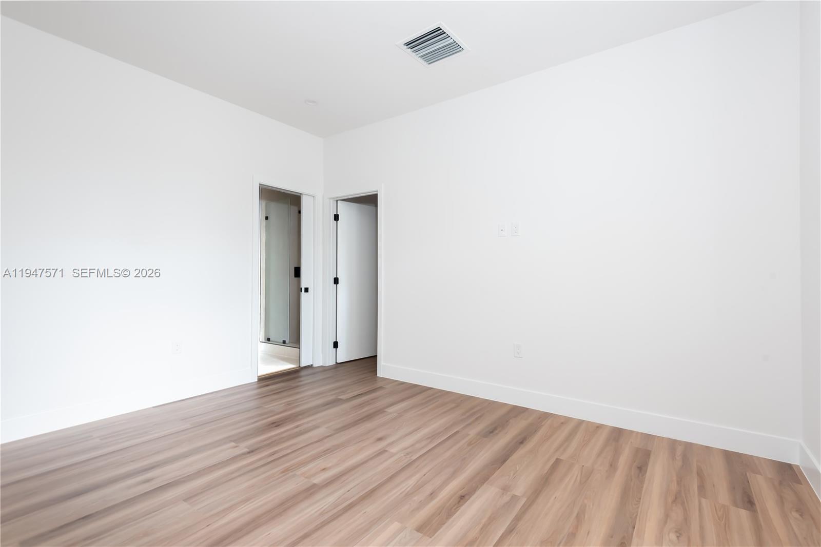 4517 Northwest 3rd Street Miami, FL 33126 - Photo 21 of 34 a view of an empty room with wooden floor
