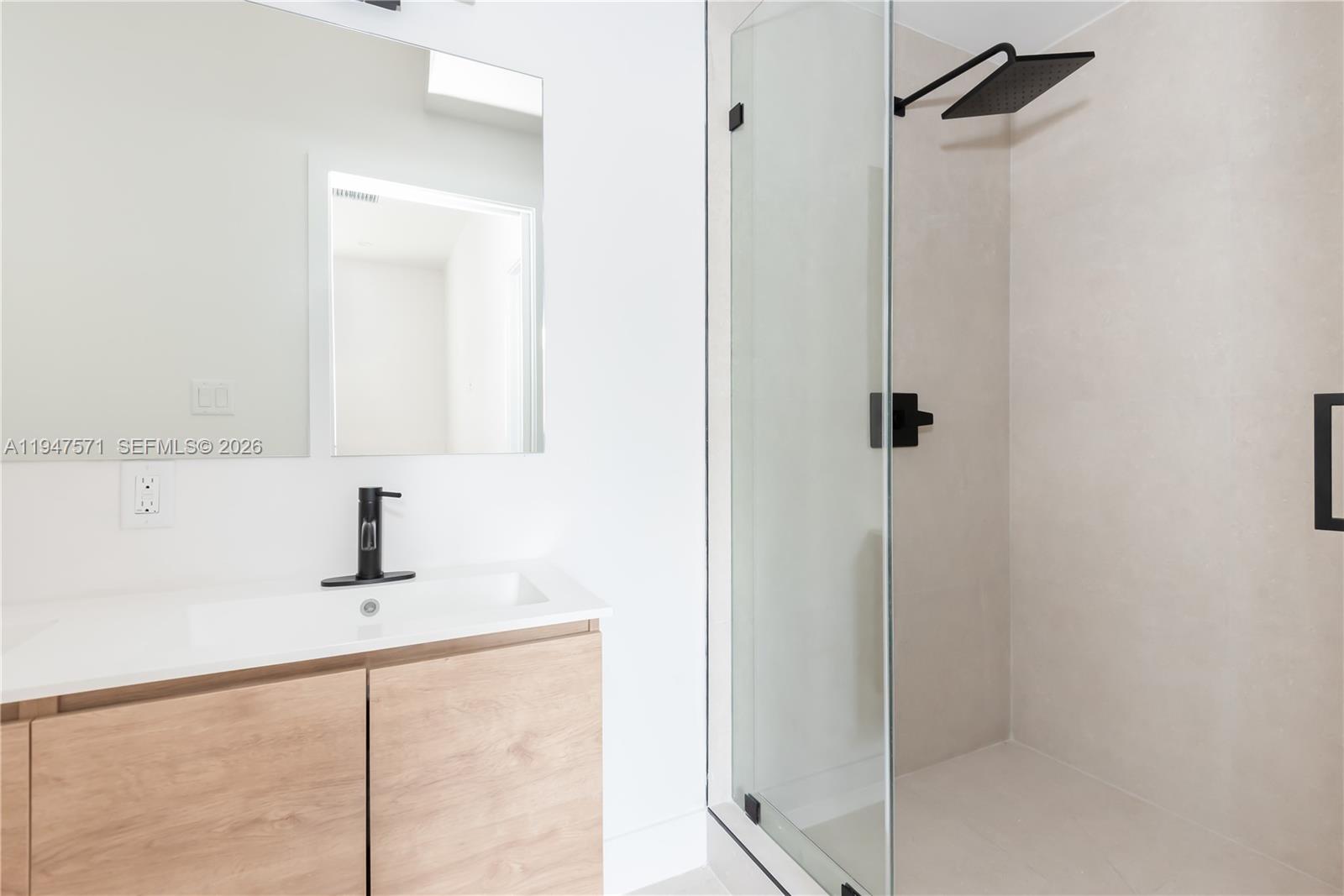 4517 Northwest 3rd Street Miami, FL 33126 - Photo 25 of 34 a bathroom with a sink and a mirror