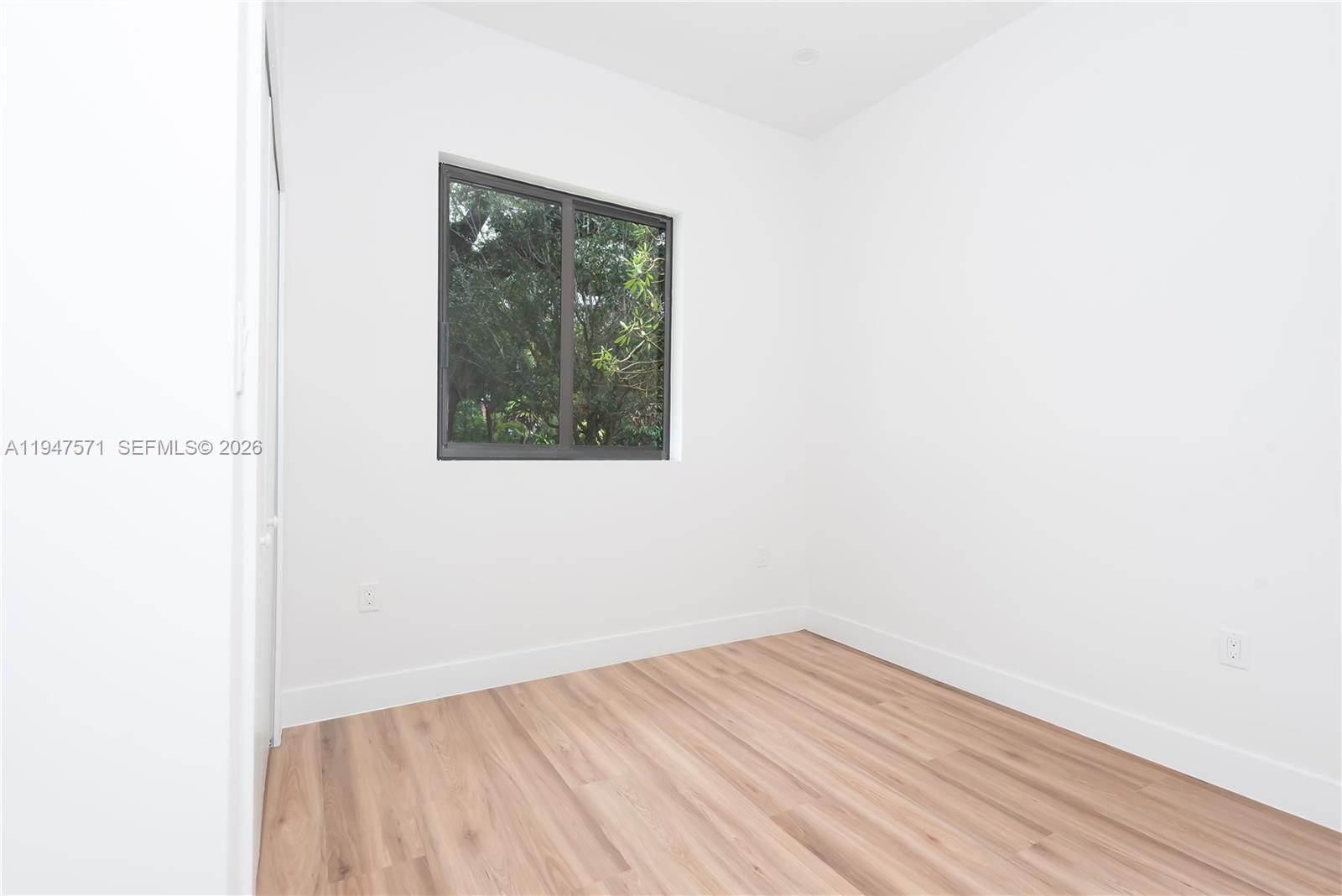 4517 Northwest 3rd Street Miami, FL 33126 - Photo 33 of 34 a view of a small space with wooden floor and a window