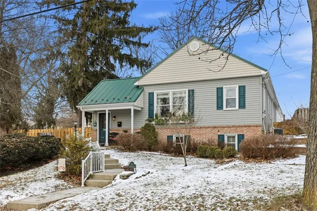 a view of a house with a yard covered in snow