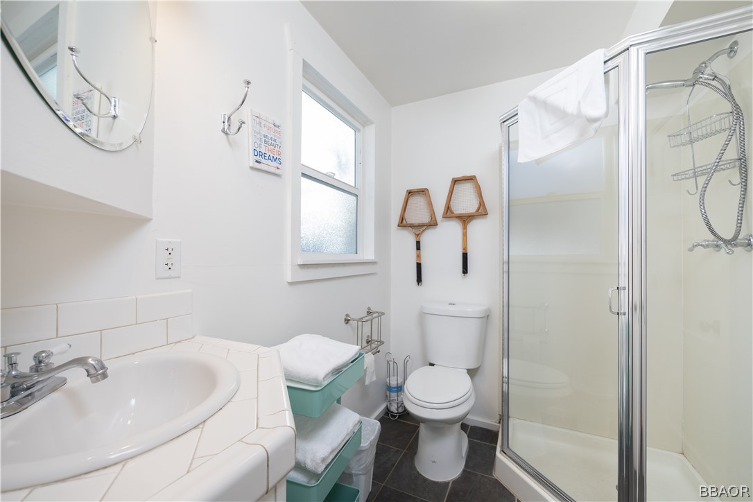 408 Conklin Road Big Bear Lake, CA 92315 - Photo 19 of 24 a bathroom with a toilet sink and mirror