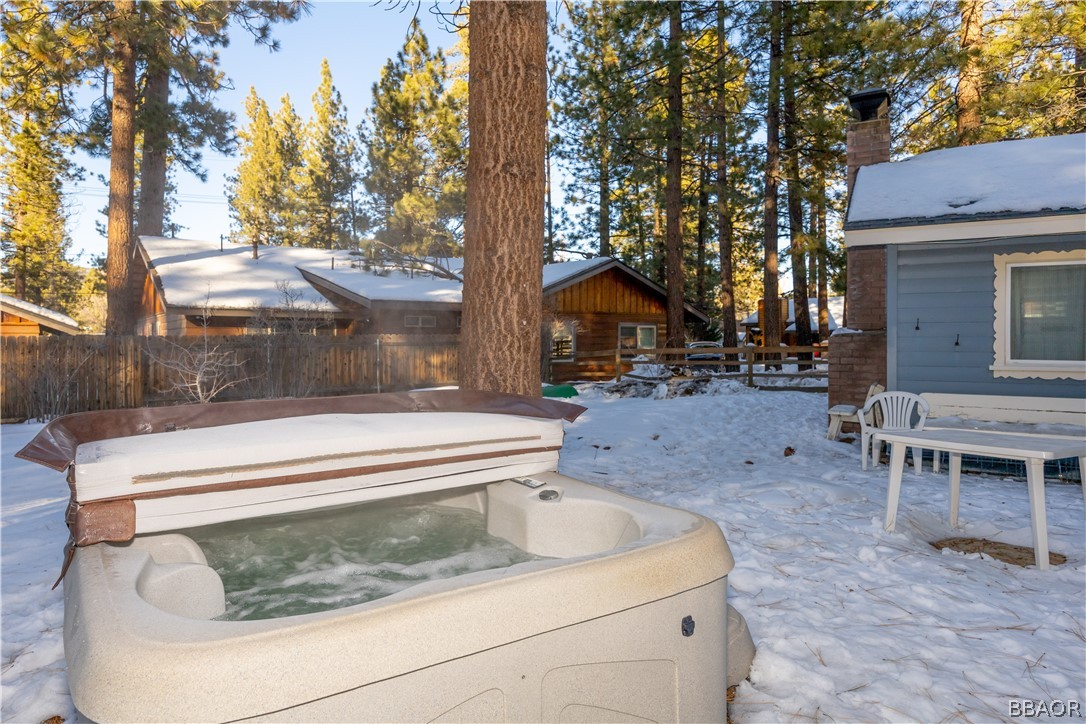 408 Conklin Road Big Bear Lake, CA 92315 - Photo 21 of 24 a backyard of a house with large trees and wooden fence