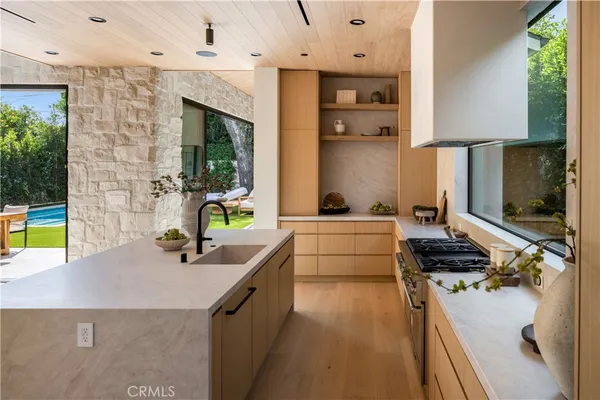 a kitchen with stainless steel appliances granite countertop a sink and a stove