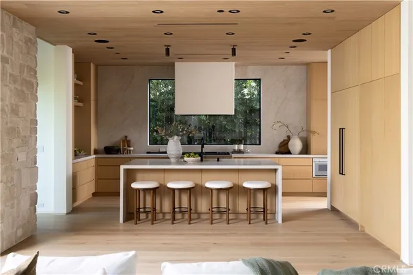 a kitchen with a sink and chairs