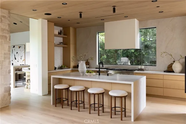a kitchen with center island table and chairs