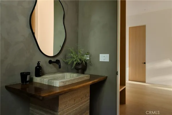 a view of a hallway with wooden floor and windows