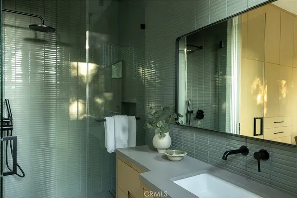 a spacious bedroom with a bed and glass door