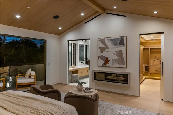 a bedroom with furniture and a painting on the wall