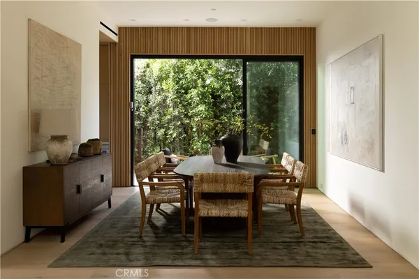a dining room with furniture and wooden floor