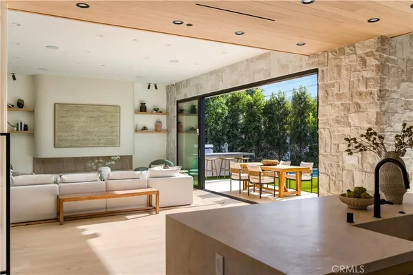 a living room with patio furniture and a fireplace