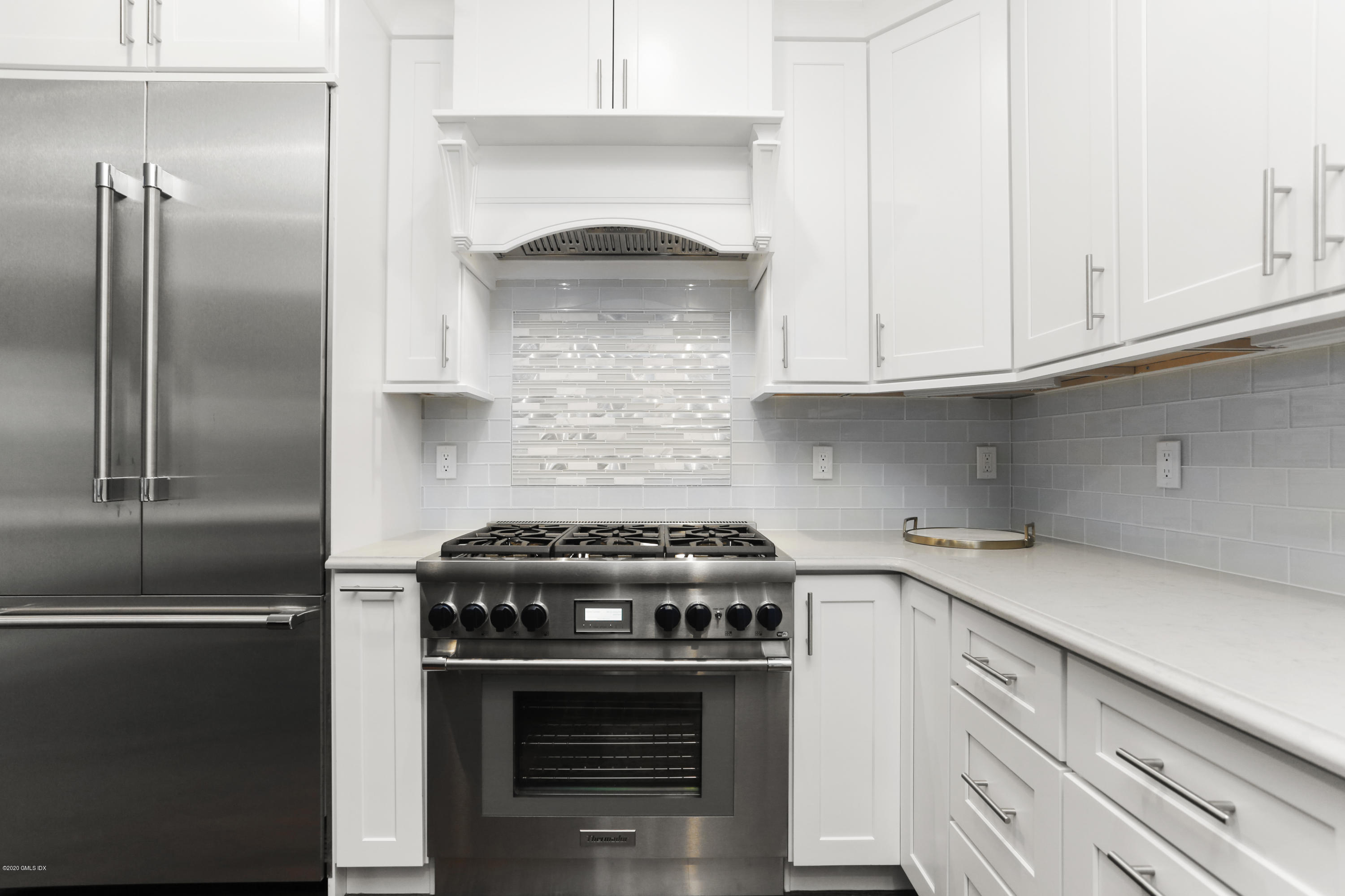 72 Riverside Lane Riverside, CT 06878 - Photo 18 of 40 a kitchen with a stove and a refrigerator