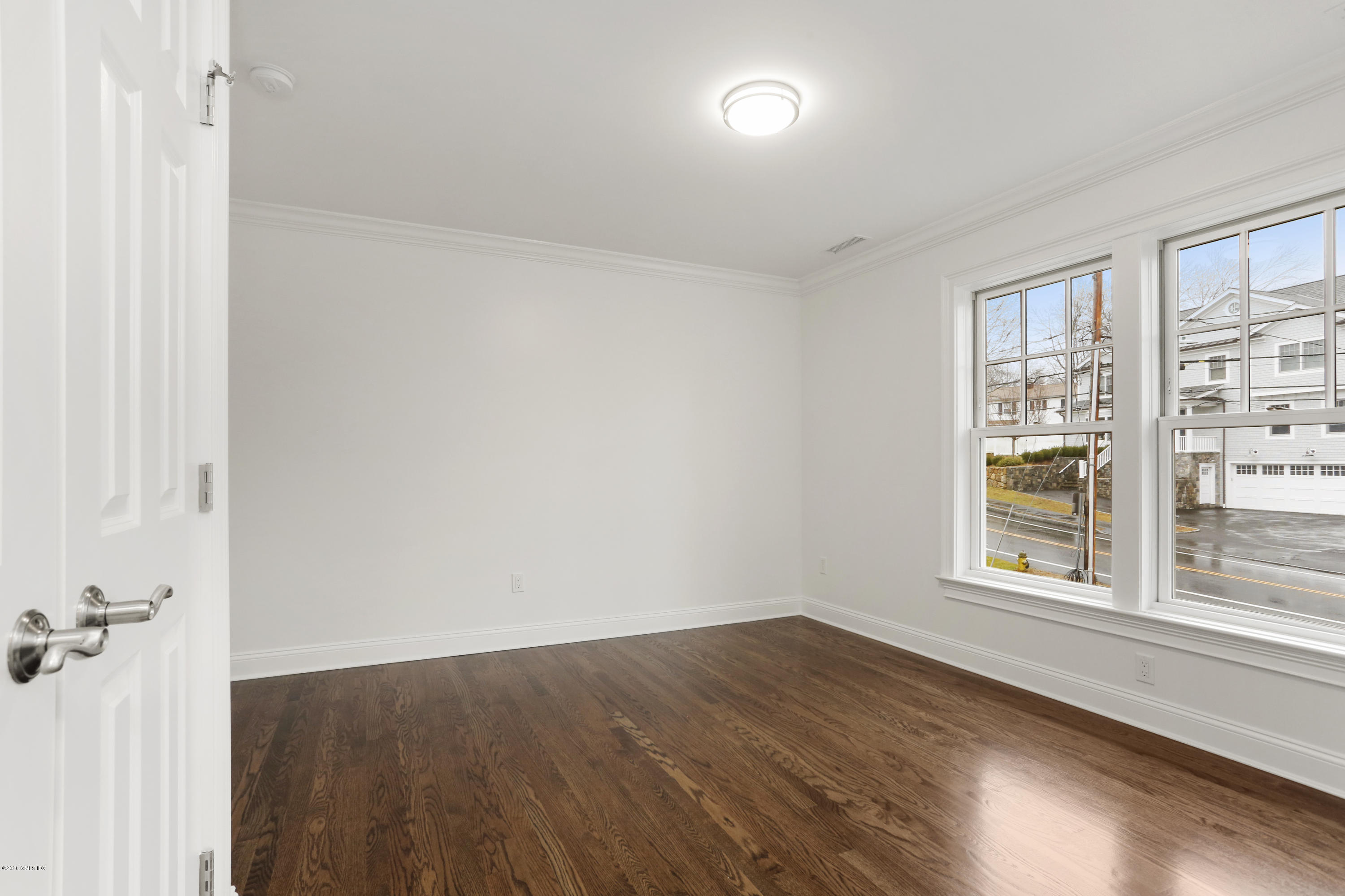 72 Riverside Lane Riverside, CT 06878 - Photo 21 of 40 a view of an empty room with wooden floor and a window