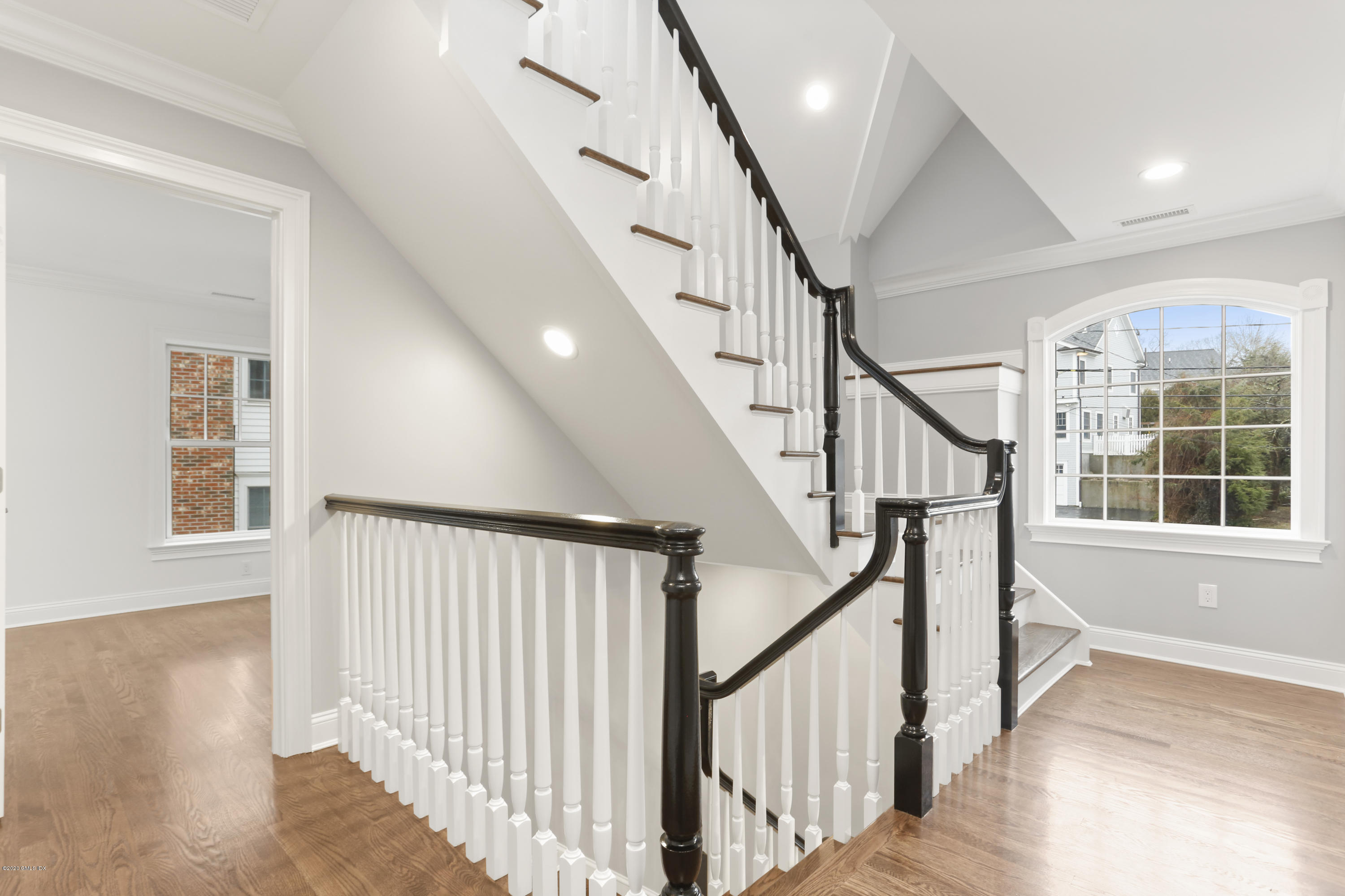 72 Riverside Lane Riverside, CT 06878 - Photo 22 of 40 a view of an entryway with wooden floor leading to a furnished livingroom and windows