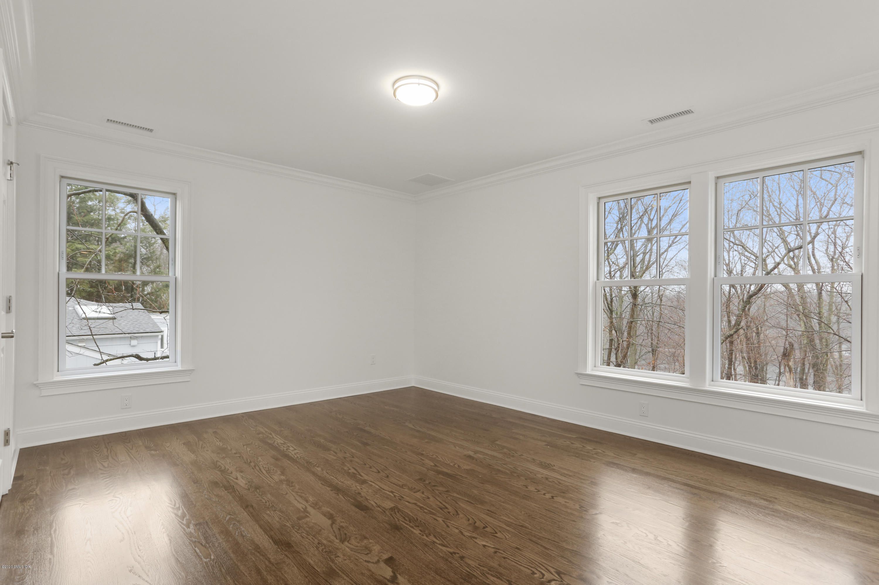 72 Riverside Lane Riverside, CT 06878 - Photo 28 of 40 a view of an empty room with wooden floor and a window