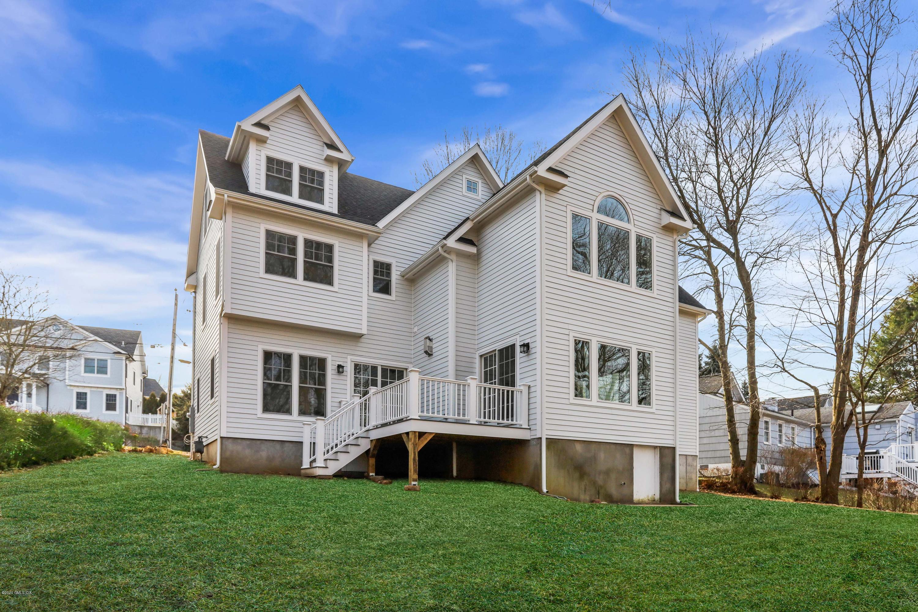 72 Riverside Lane Riverside, CT 06878 - Photo 35 of 40 a front view of a house with a yard and trees