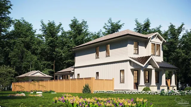 a view of a white house with large windows and a yard with plants and trees