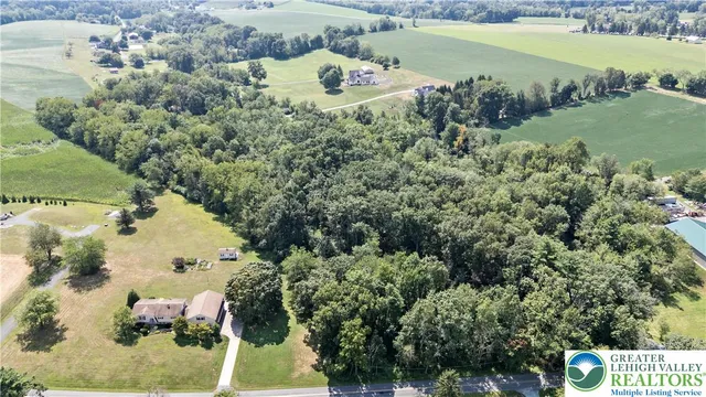 an aerial view of a house with a lake view