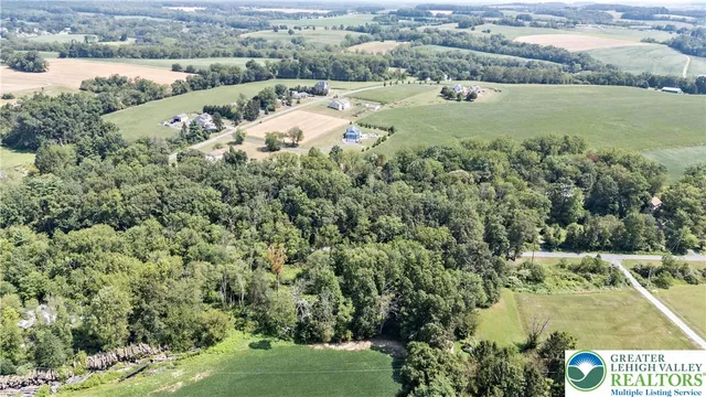 an aerial view of beach and residential houses with outdoor space