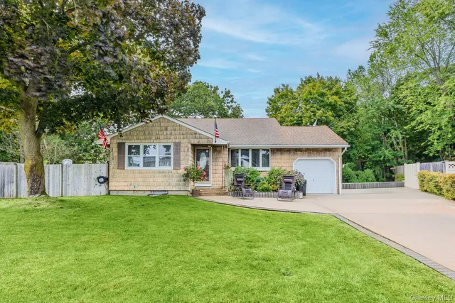 a house view with a sitting space and garden