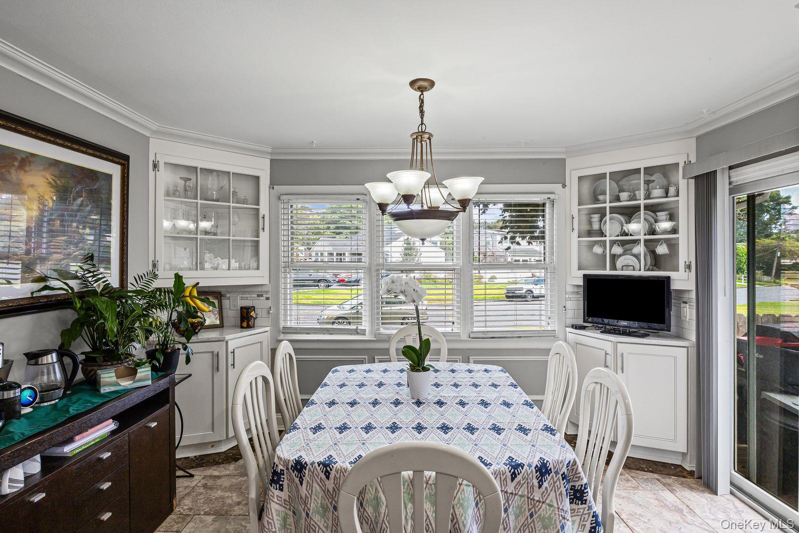 22 Larry Road Selden, NY 11784 - Photo 11 of 36 a dining room with furniture a chandelier and wooden floor