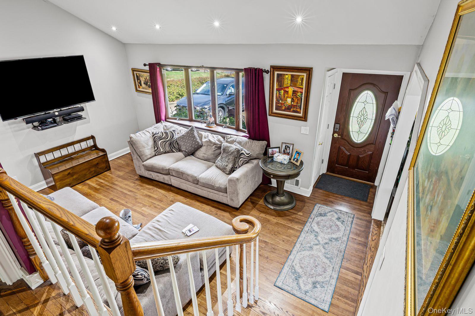 22 Larry Road Selden, NY 11784 - Photo 13 of 36 a living room with furniture and a flat screen tv