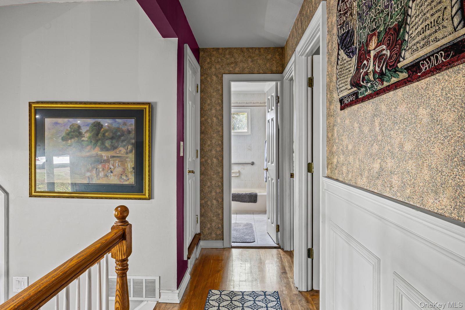 22 Larry Road Selden, NY 11784 - Photo 14 of 36 a view of hallway with paintings on the wall