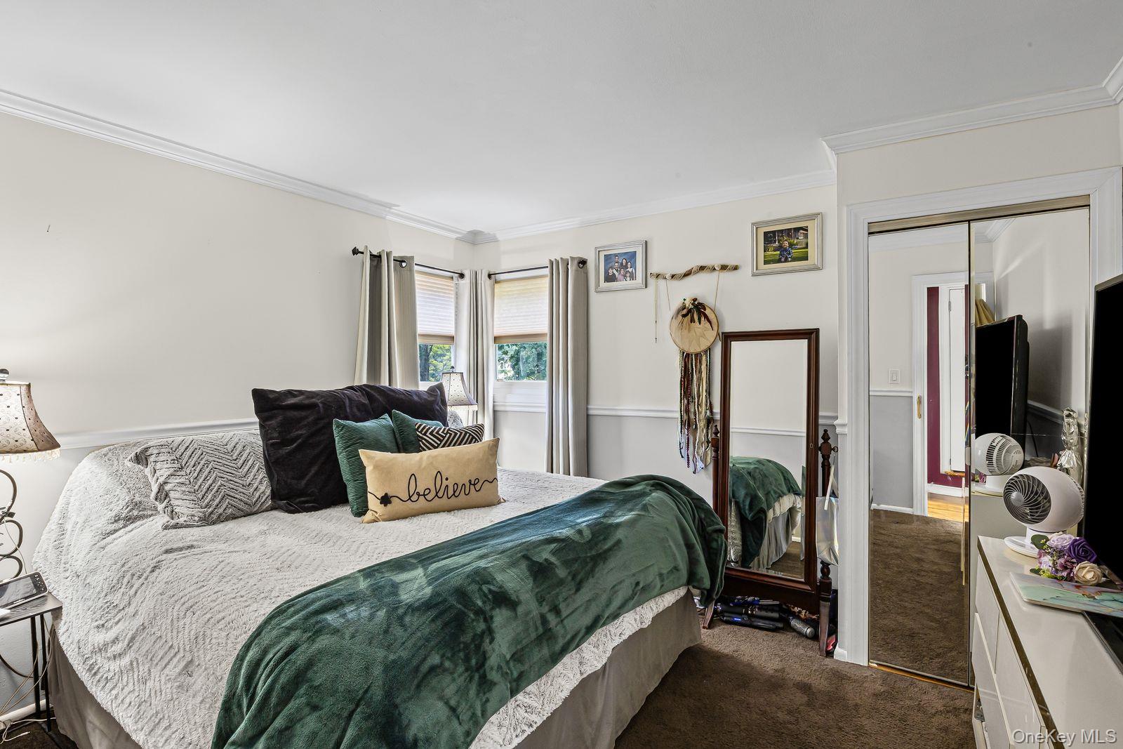 22 Larry Road Selden, NY 11784 - Photo 15 of 36 a bedroom with a bed a large window and flat screen television