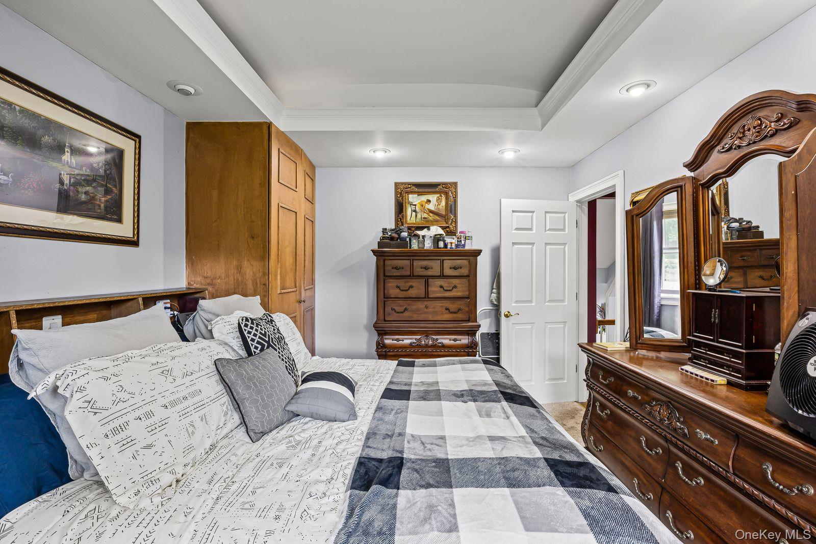 22 Larry Road Selden, NY 11784 - Photo 18 of 36 a bedroom with a bed and a dresser