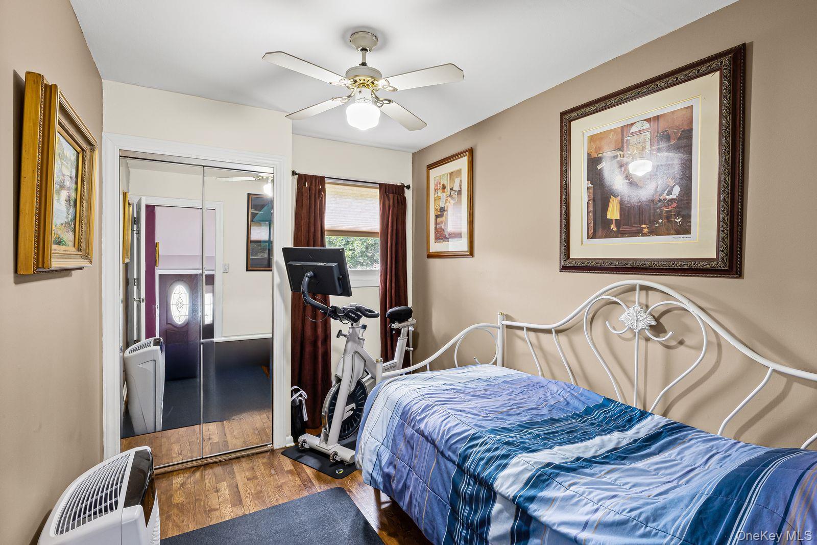 22 Larry Road Selden, NY 11784 - Photo 19 of 36 a bedroom with a bed and a chandelier