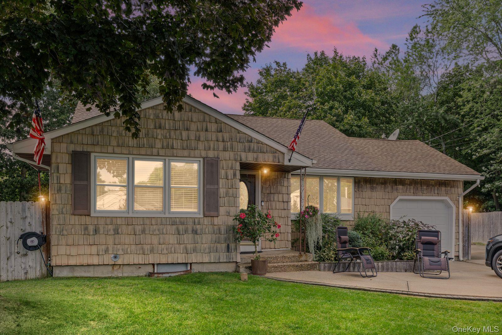 22 Larry Road Selden, NY 11784 - Photo 2 of 36 a front view of a house with a garden