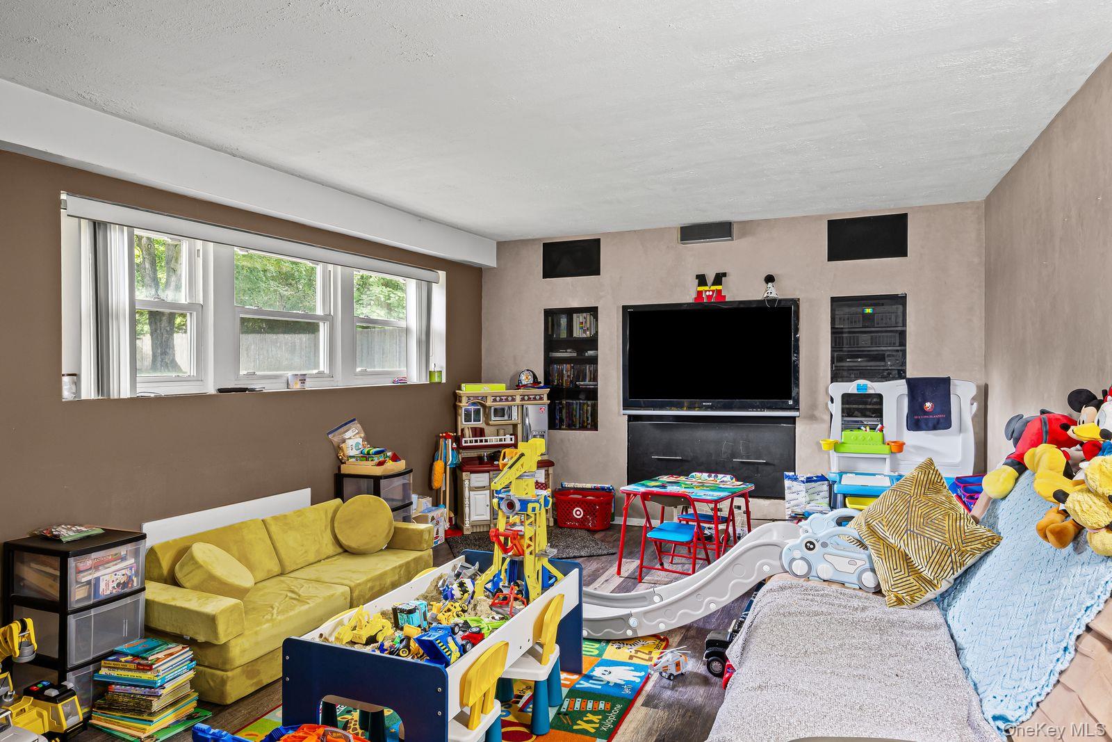 22 Larry Road Selden, NY 11784 - Photo 21 of 36 a living room with furniture and a flat screen tv