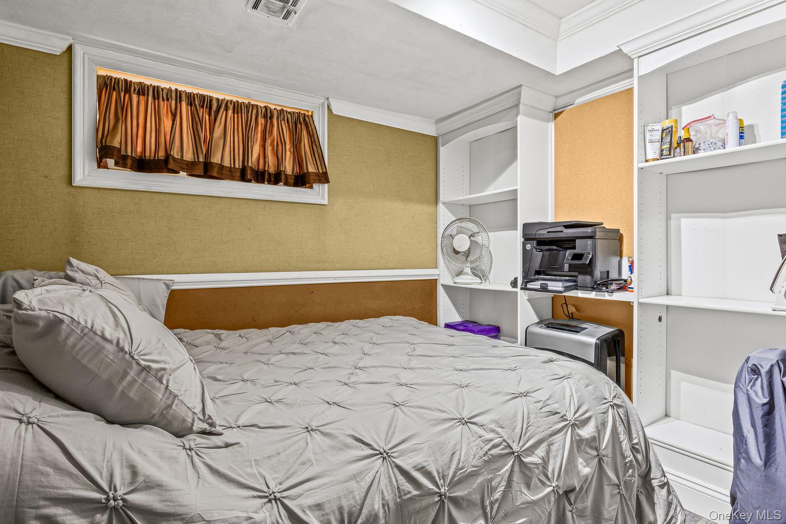 22 Larry Road Selden, NY 11784 - Photo 22 of 36 a bedroom with a bed and a window