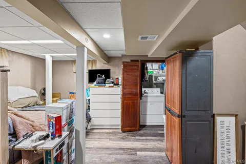 a view of a deck with wooden floor and fence next to a yard