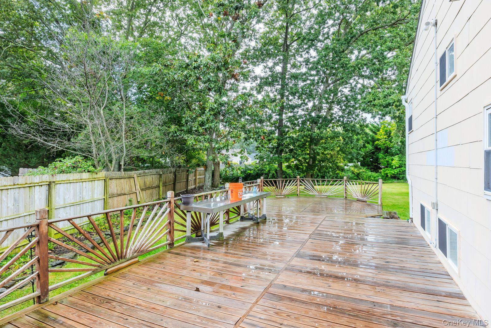 22 Larry Road Selden, NY 11784 - Photo 30 of 36 a view of a deck with chairs and wooden floor