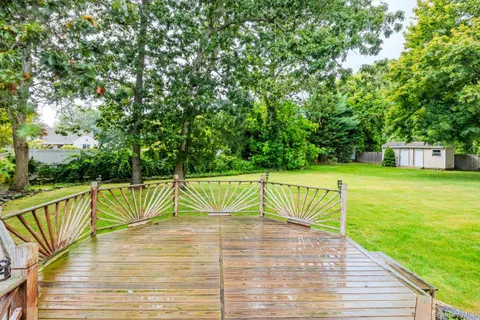 a view of a backyard with wooden fence