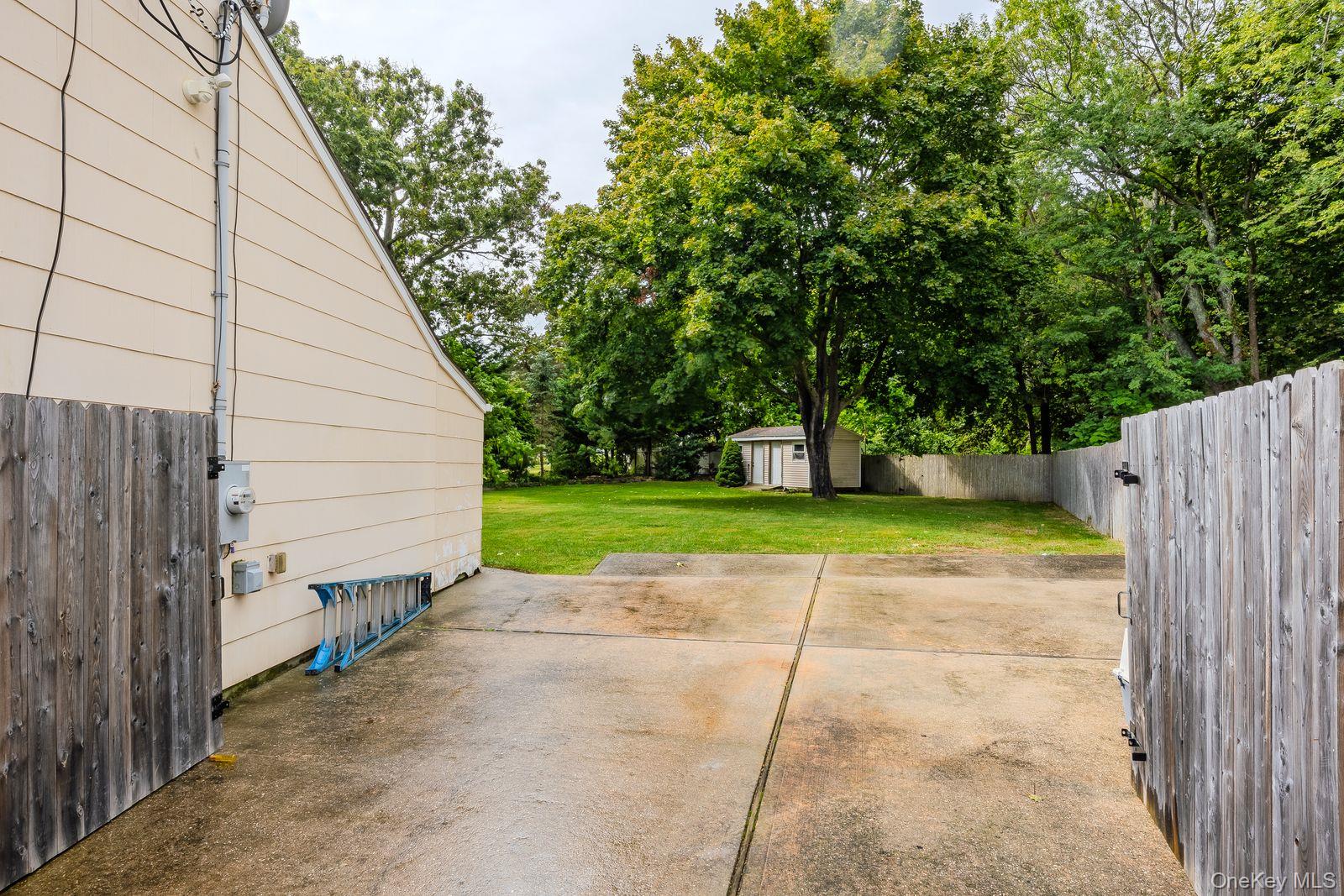 22 Larry Road Selden, NY 11784 - Photo 32 of 36 a view of a backyard with wooden fence