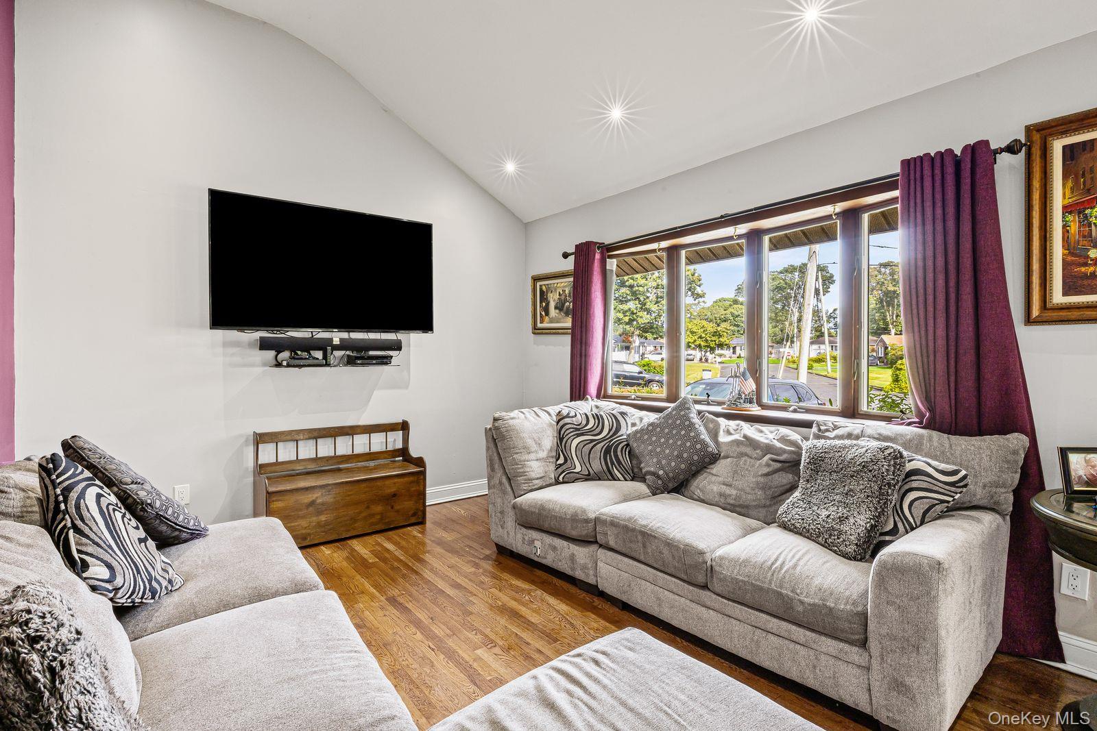 22 Larry Road Selden, NY 11784 - Photo 5 of 36 a living room with furniture and a flat screen tv