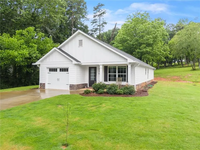 a view of a house with a yard and garage