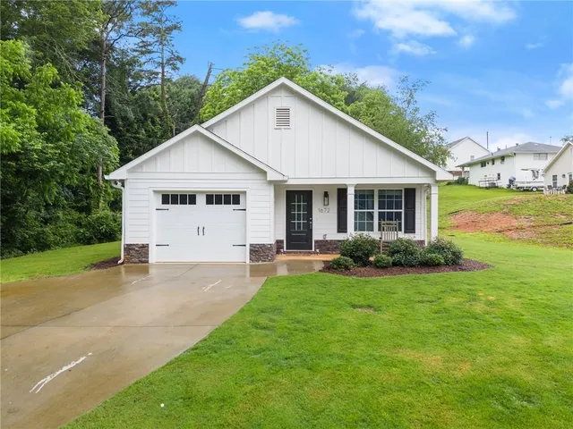 a view of a house with a yard and garage