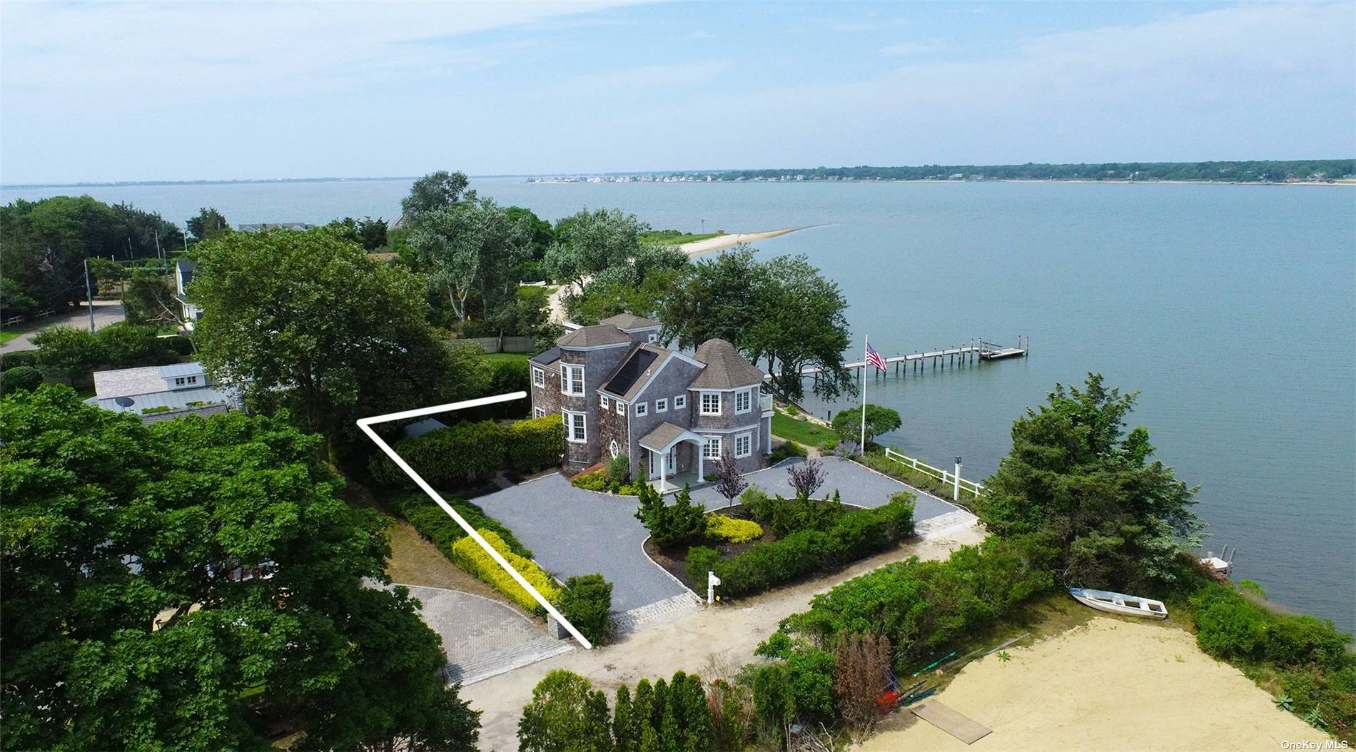 an aerial view of house with outdoor space and lake view