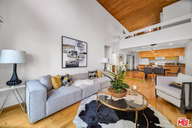 a living room with furniture and a lamp