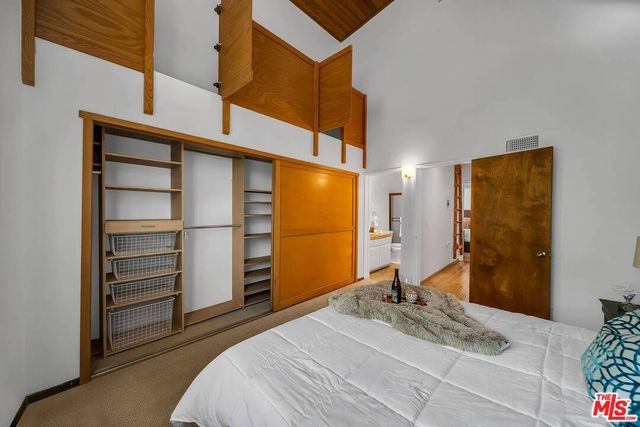 a bedroom with a bed and a walk in closet