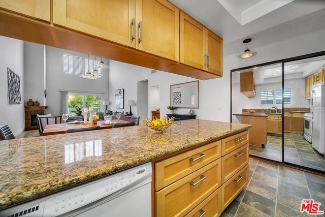 a kitchen with stainless steel appliances granite countertop a sink and cabinets