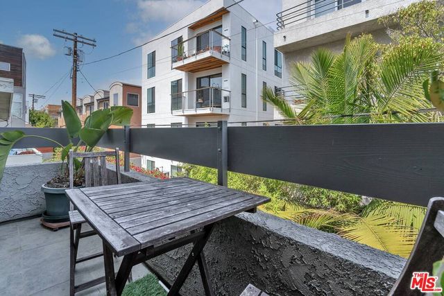 a wooden bench sitting in front of a building