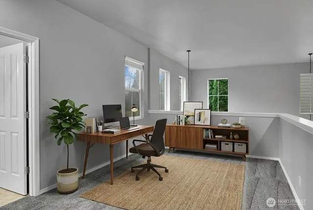 a view of a workspace with furniture and a potted plant