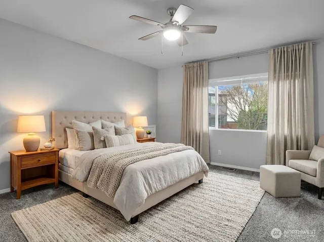 a bedroom with a large bed and a window