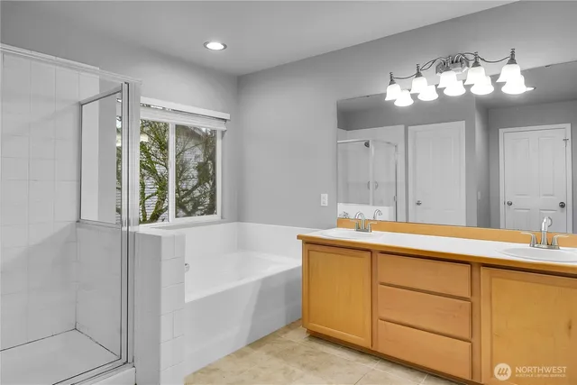 a bathroom with a tub sink and mirror